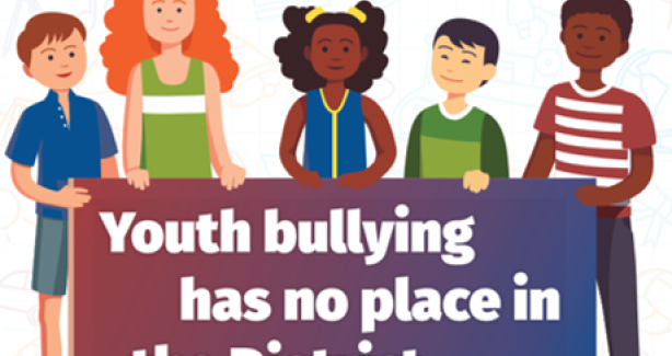 There are five children of different race and genders holding a sign saying 'youth bullying prevention poster'